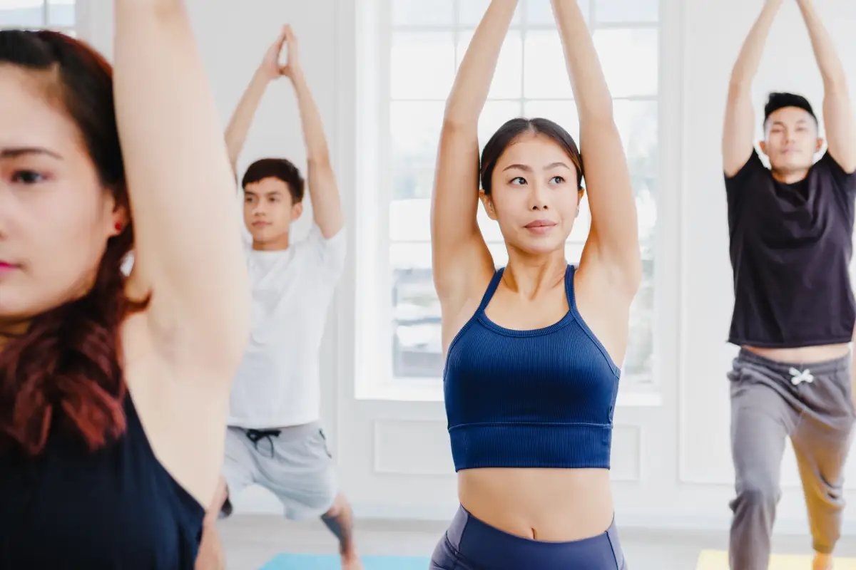 Group exercising in a fitness class, supporting healthy lifestyle habits that help reduce risk of diseases that cause cataracts