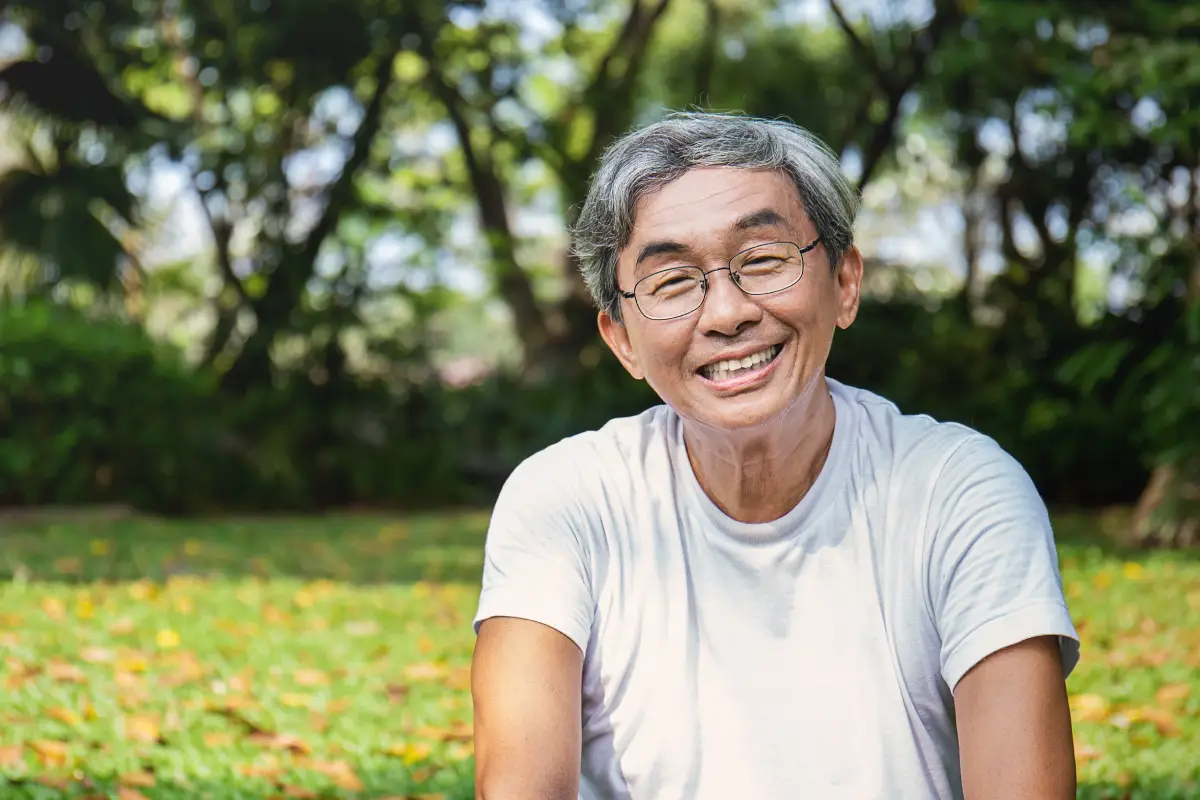 Middle-aged man wearing glasses, representing early cataract symptoms affecting vision clarity