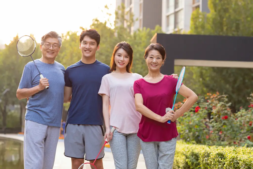  Active multi-generational Asian family outdoors with clear vision after cataract surgery and follow-up eye care.