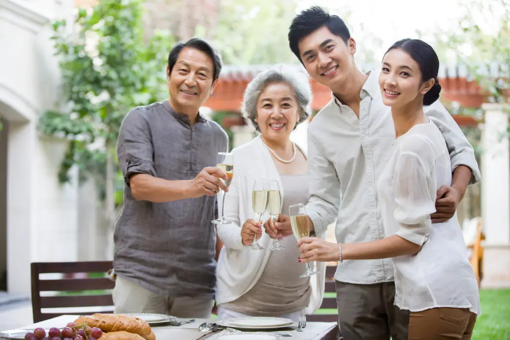 Asian family outdoors, highlighting healthy ageing and awareness of cataract-related eye conditions.