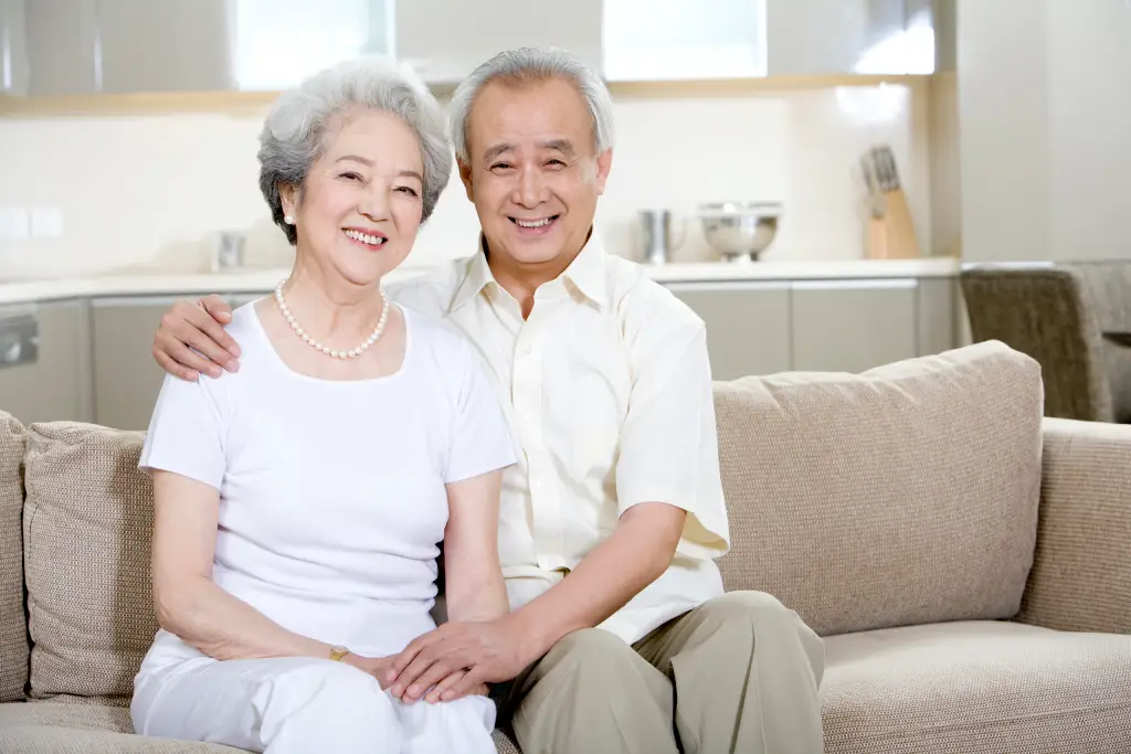 Smiling adults, representing healthy vision and awareness of cataract-related eye conditions.